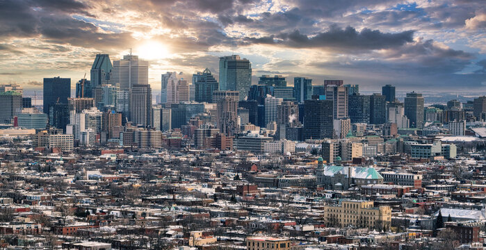 Montreal city downtown skyscrapers with sunrise behind the buildings