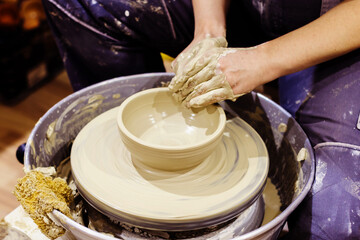 Woman Pottery Artist. Workshop Molding Clay On Pottery Wheel. Ceramic Studio. Closeup View On Female Hands.