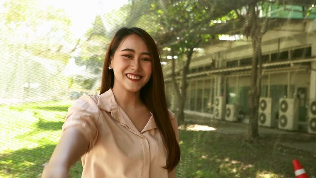 Portrait beautiful Asian woman with long hair, beautiful face, looking at the camera, greeting, smiling, cheerful, charming in Thai style, close-up photo. slow motion video.