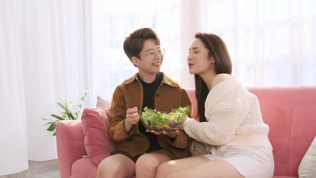 Lesbian woman feed salad to lovers,snuggle and tease each other.