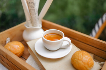 espresso coffee glass cup with breads, and old paper roll and on vintage brown book.coffee break concept