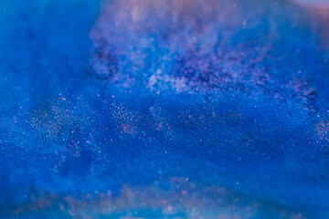 Paints blend. Abstract background design. Blue pink glitter inks mix