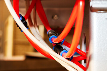 orange duct tubes of pneumatic system connected by the fittings