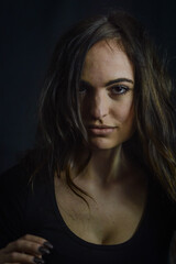 Close up portrait of a beautiful Italian woman with long hair and an intense and seductive gaze