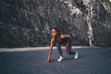 Fototapeta premium Pumped up jogger in sportswear ready for sprinting during morning cardio training - pursuit challenge, Caucasian female athlete feeling motivation for speed running - workout endurance concept