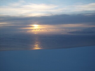 Sunset over ice cap and sea