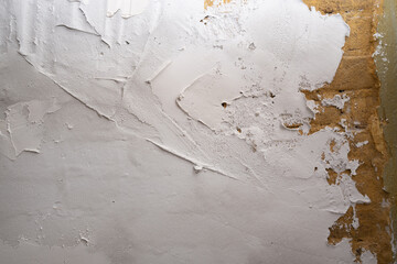 Industrial background. Structural plaster on the wall. Brick wall with plaster stains
