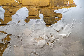 Industrial background. Structural plaster on the wall. Brick wall with plaster stains