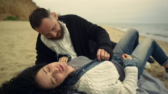 Sensual couple relaxing beach. Pretty lovers lying enjoying honey moon on nature