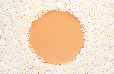 Organic soy wax on beige background with copy space for design, text. Top view. Round, a circle...