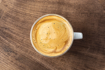 cup of espresso on wooden background top view