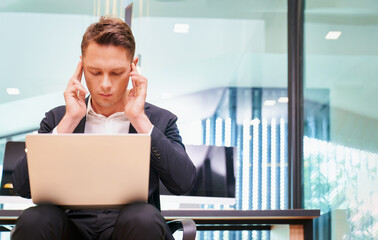 Smart Businessman have headache and take relax from hard work and issue with laptop in office