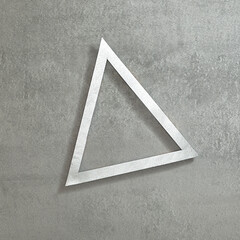Simple triangular silver frame on a concrete gray background. Text space. Top view. Minimal style.
