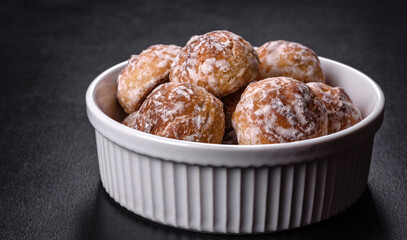 Tasty homemade gingerbread cookies on dark concrete table