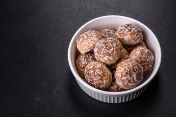 Tasty homemade gingerbread cookies on dark concrete table