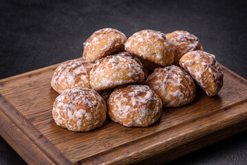 Tasty homemade gingerbread cookies on dark concrete table