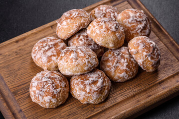 Tasty homemade gingerbread cookies on dark concrete table