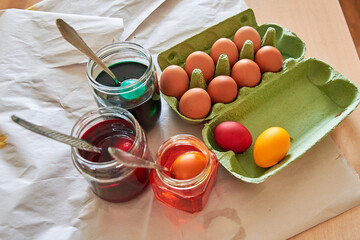 preparation for the Easter holiday, coloring eggs at home, tissue with spoons