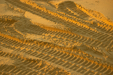 Tire tread marks on sand