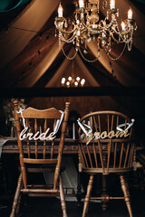 Vintage wooden chairs in a restaurant. Chairs for the bride and groom