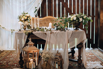 Wedding table for the bride and groom with beautiful decor in a rustic style