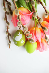 easter greeting card. pink tulips, willow branches and colorful Easter eggs 