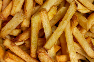 Crispy French fries background closes up image.