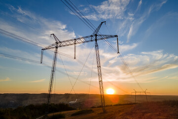 Obraz premium High voltage tower with electric power lines at sunset. Transmission of electricity