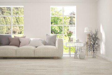 White living room with sofa and summer landscape in window. Scandinavian interior design. 3D illustration