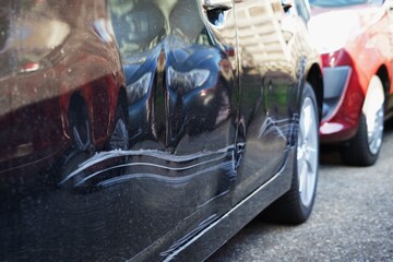 Scratches on a car door. Vertical scratches a result of a collision. Damage on both left door...