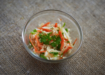 Lunch Time. Garnish. Vegetable salad with shredded carrots, cabbage, greens and sunflower oil.