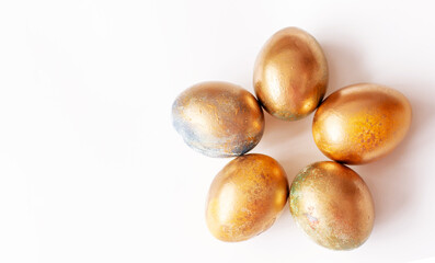 Golden eggs on a white background . Easter Concept