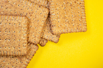 Rye biscuits, close up on yellow background