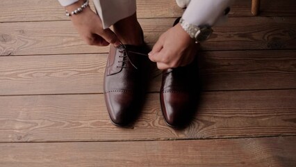 man in suit putting on new shoes