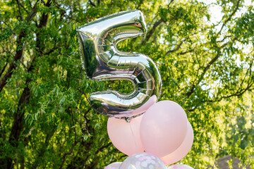 Silver balloon in the form of number 5