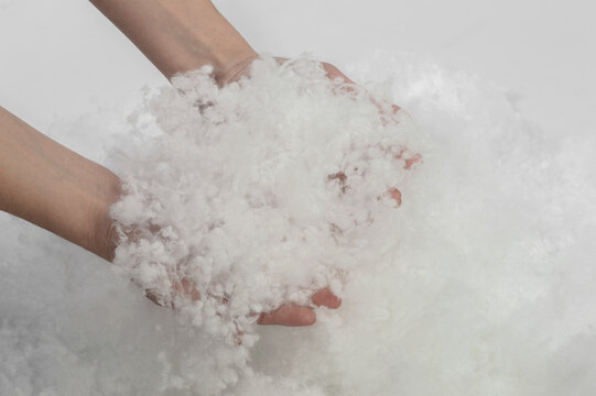 Holofiber. Natural filler for pillows and blankets in female hands