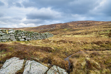 Drystone wall on the peatlands of the Isle of Lewis in the outer Hebrides, Scotland