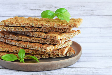 Crackers with a high fiber content, buckwheat crackers in a clay plate.Crispy buckwheat bread.Healthy eating.