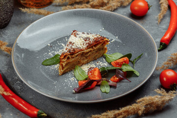 Homemade delicious Meat lasagna with basil leaf on the top. Close up. Recipe, menu. Italian cuisine. Side view