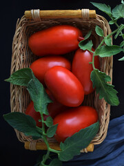 Ripe tomatoes in a wicker basket.Vegetarian food.