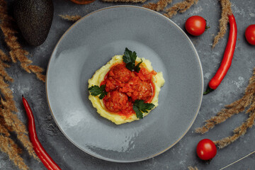 Meatballs in tomato sauce with mashed potato on the white plate, top view, view from above