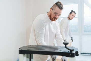 carpenters working with wood on the planing machine