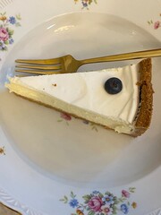 Classic cheesecake top view. Cheesecake slice on the plate. Dessert close up