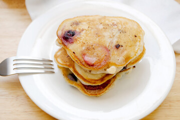 Healthy Strawberry and Blueberry Pancakes Served on a White Plate