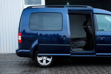 Compact blue van, with beautiful wheels, large chrome grille.