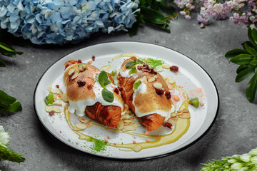 croissant with sweet cream and almonds on a plate. Delicious and healthy breakfast