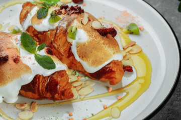 croissant with sweet cream and almonds on a plate. Delicious and healthy breakfast