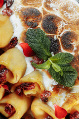 Pancakes with cheese in orange sauce served with caramelized nuts and almonds. Appetizing dish. Culinary photography, a proposal to serve a meal