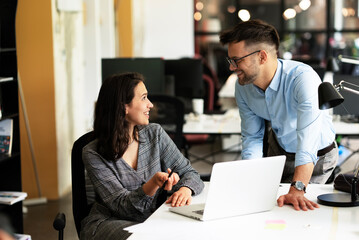 Colleagues in office. Businesswoman and businessman discussing work in office