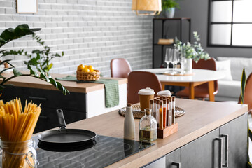Counters with spices and utensils in kitchen